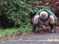 UhFuck presents: Short hair blonde in a parking lot goes pee