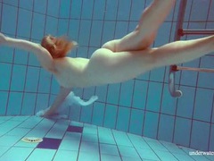 UhFuck presents: Redhead goes for a nude swim in the pool